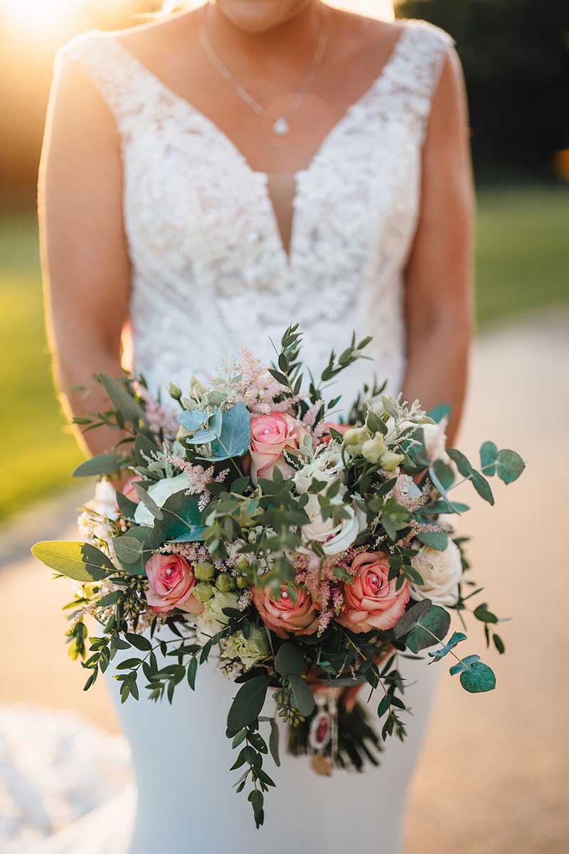 Bride holding wedding bouquet flowers